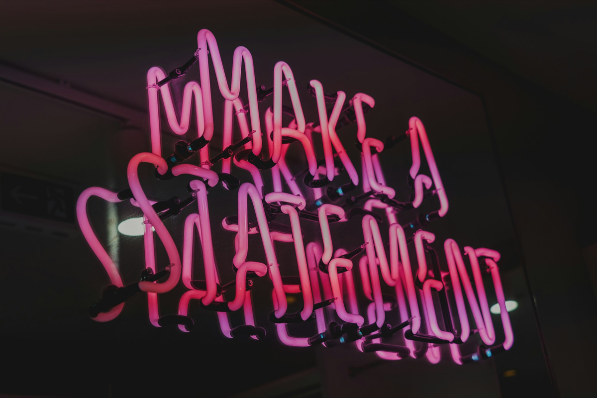 Bright pink neon sign saying "Make a statement"